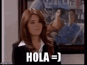 a woman in a suit is standing in front of a framed picture and says hola = j .