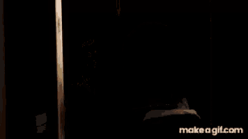 a person is standing in a dark room with a make a gif.com watermark on the bottom