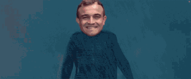 a man in a black jacket is holding up a red light