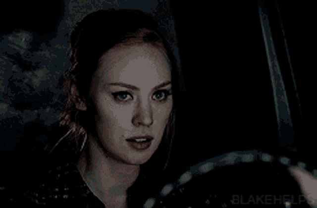 a woman in a car with blakehelps written on the bottom right