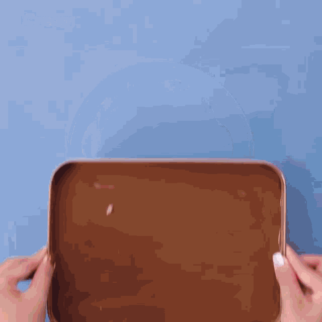 a person is holding a tray that says bake 350 degrees f 1/2 hour