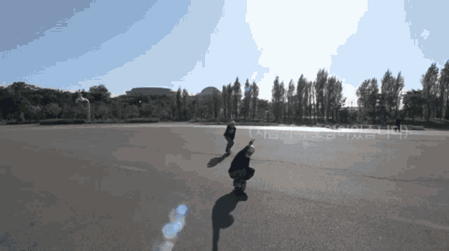 a person riding a skateboard on a road with chinese writing on the side