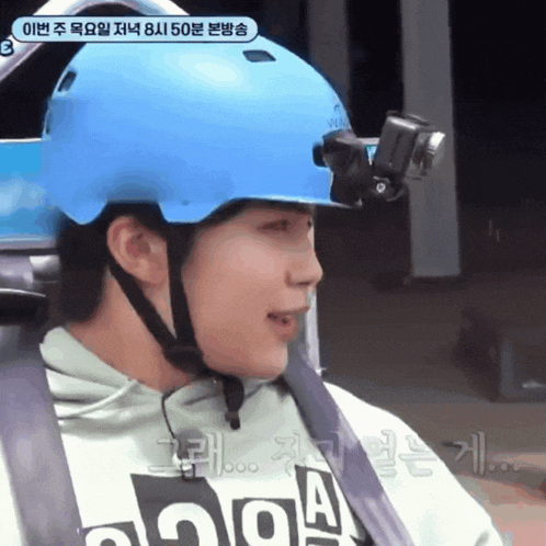 a man wearing a blue helmet with a camera attached