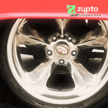 a close up of a car wheel with a zypto logo in the background
