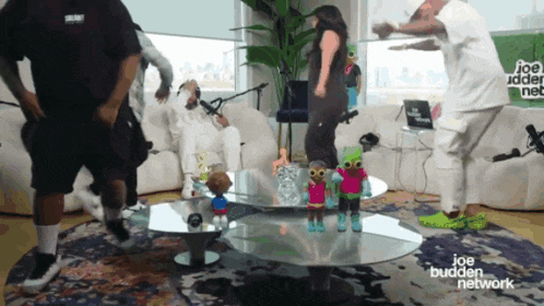 a group of people are dancing in front of a joe budden network logo