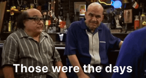 two men are sitting at a bar with the words " those were the days " on the screen