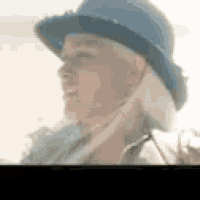 a close up of a person wearing a hat