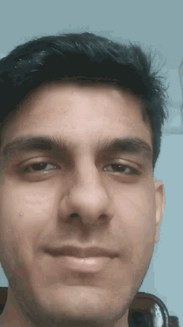 a close up of a man 's face with a smile