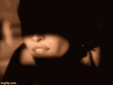 a close up of a woman 's face with a veil covering her face .