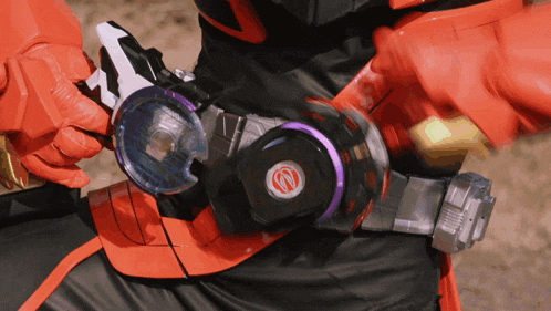 a close up of a person 's belt with a red circle on it