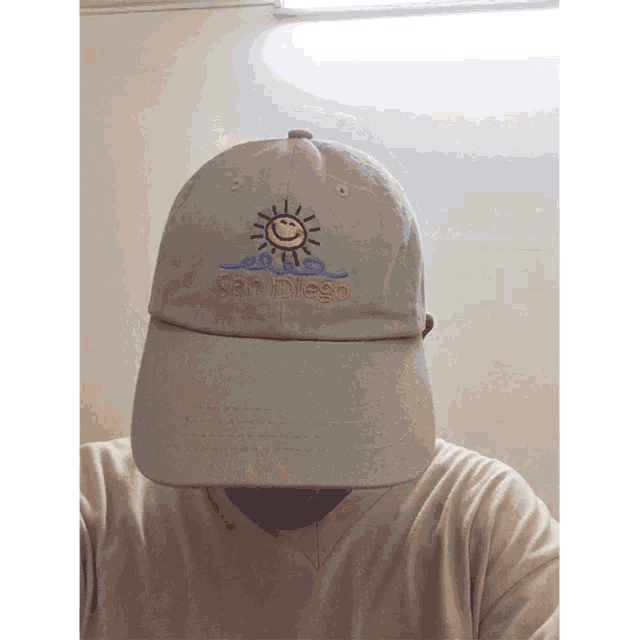 a man wearing a san diego hat with a smiley face on it