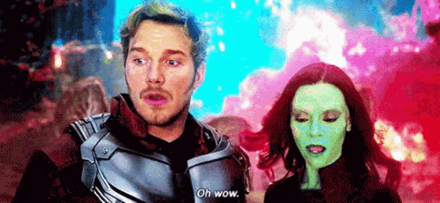 a man and a woman are standing next to each other and the woman is wearing a green face .