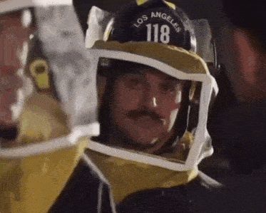 a man wearing a helmet that says los angeles 118 on it