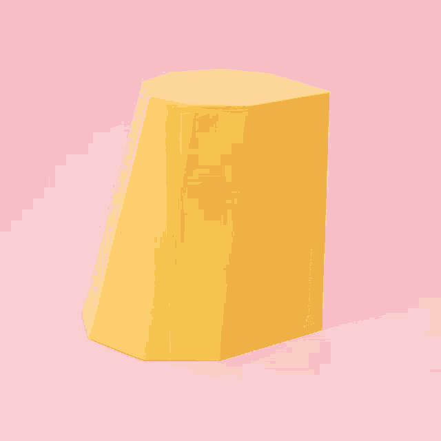 a yellow hexagon shaped object is on a pink background