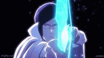 a man is holding a blue sword in his hands in a dark room .