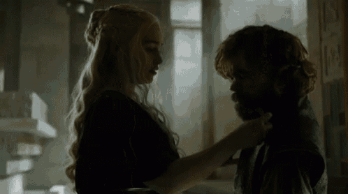 a man and a woman are standing next to each other and touching each other 's necks .