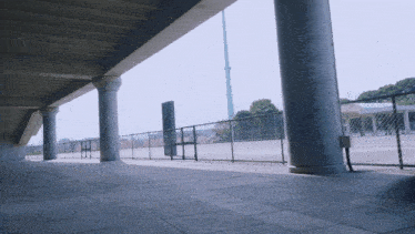 a fenced in area with columns and a sign that says ' stadium '