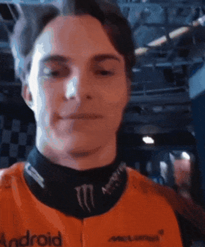 a man wearing an orange vest that says android