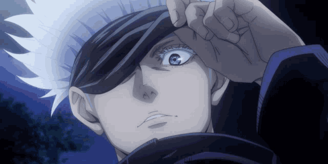 a close up of a person 's face with their hand on their forehead
