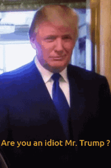 a man in a suit and tie is being asked if he is an idiot