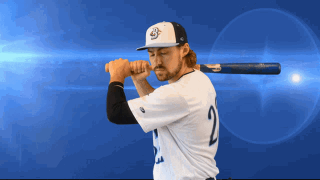 a baseball player with the number 2 on his shirt is holding a bat