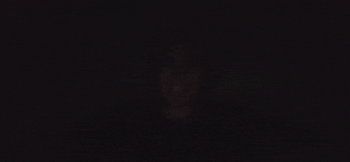 a blurry picture of a person 's face in the dark