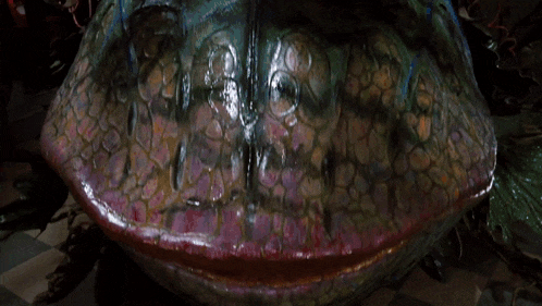 a close up of a monster mouth with the word tough written on it