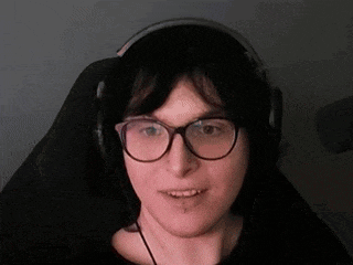 a woman wearing glasses and headphones is smiling .