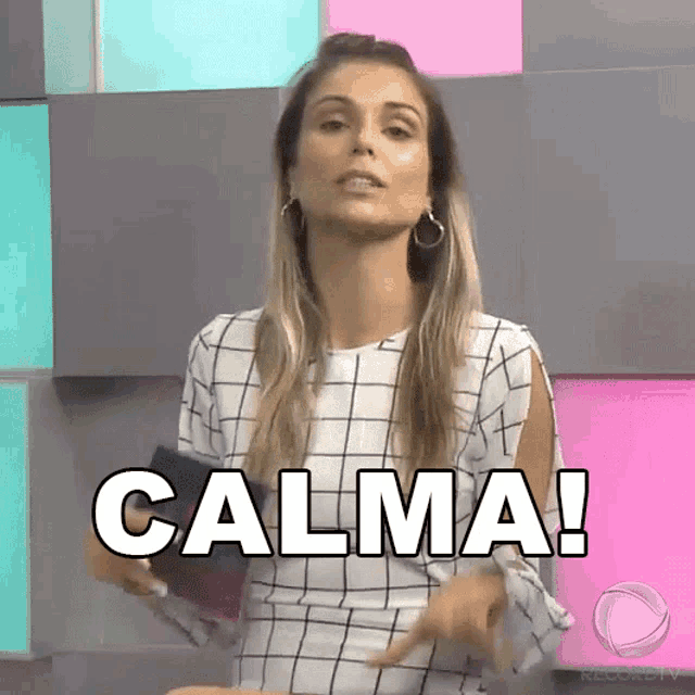 a woman is pointing at the word calma