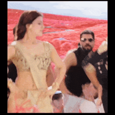 a man and a woman are dancing in front of a red background .