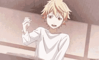 a boy with blonde hair is wearing a white shirt and standing in a room .