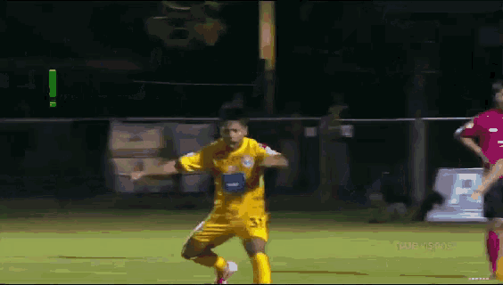 a soccer player wearing a yellow jersey with the number 31 on it is running on the field
