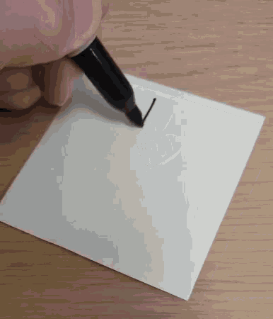 a person is writing on a piece of paper with a pen .
