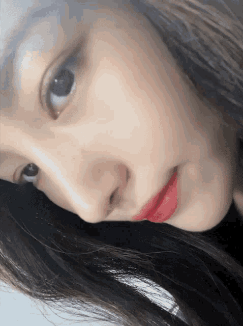 a close up of a woman 's face with red lipstick on her lips