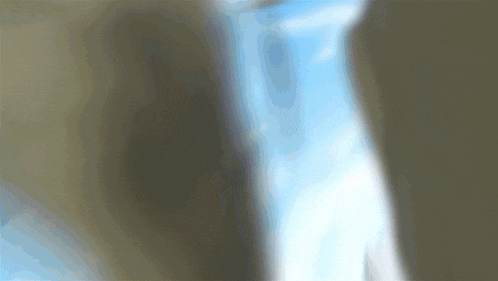 a blurry image of a blue sky with a few clouds