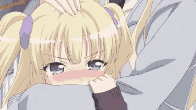 a girl with blonde hair and green eyes is being comforted
