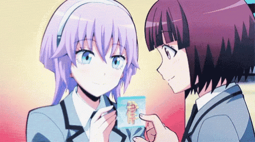 a couple of anime girls are standing next to each other and one of them is holding a piece of paper with chinese characters on it .