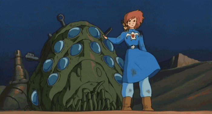 a cartoon character in a blue dress stands next to a green monster