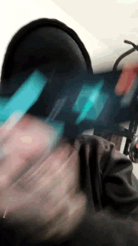 a blurry picture of a person wearing headphones and holding a phone