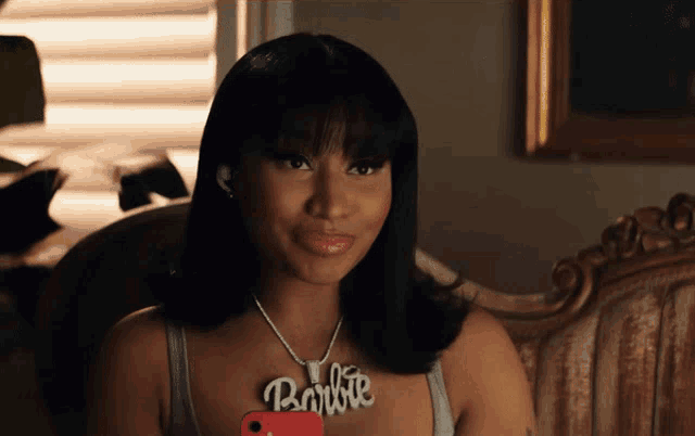 a woman with a necklace that says barbie