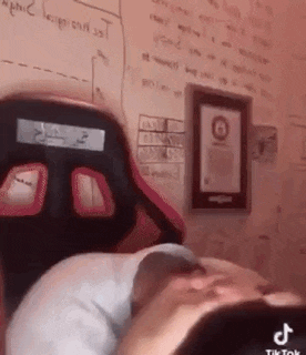 a person is laying on a bed with their head on a pillow .