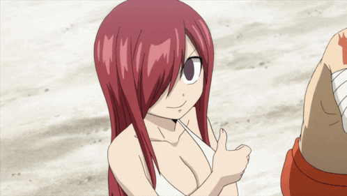 a girl with red hair gives a thumbs up