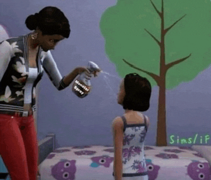 a woman is spraying a little girl 's hair with a spray bottle that says monster spray