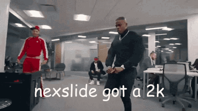 a man is dancing in an office with the words nexslide got a 2k behind him