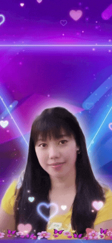 a woman in a yellow shirt stands in front of a purple background