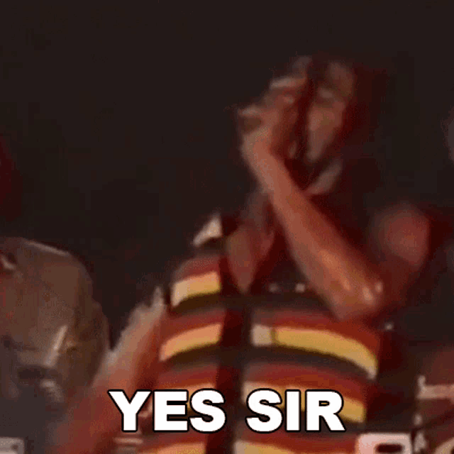 a man in a life jacket is holding a microphone and saying yes sir