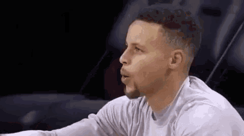 a basketball player is sitting in the stands during a game .
