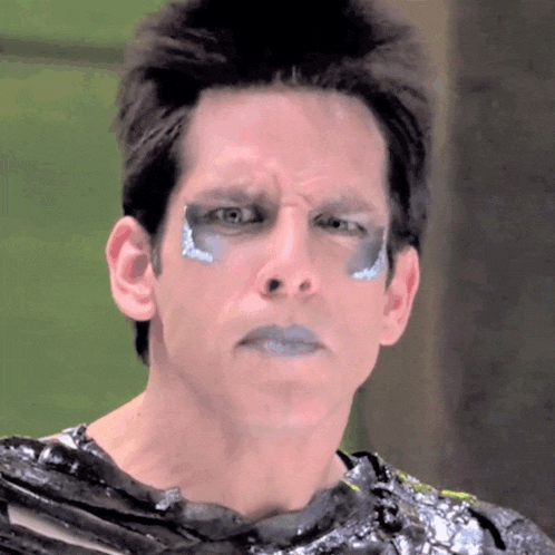 a close up of a man 's face with blue paint on his face