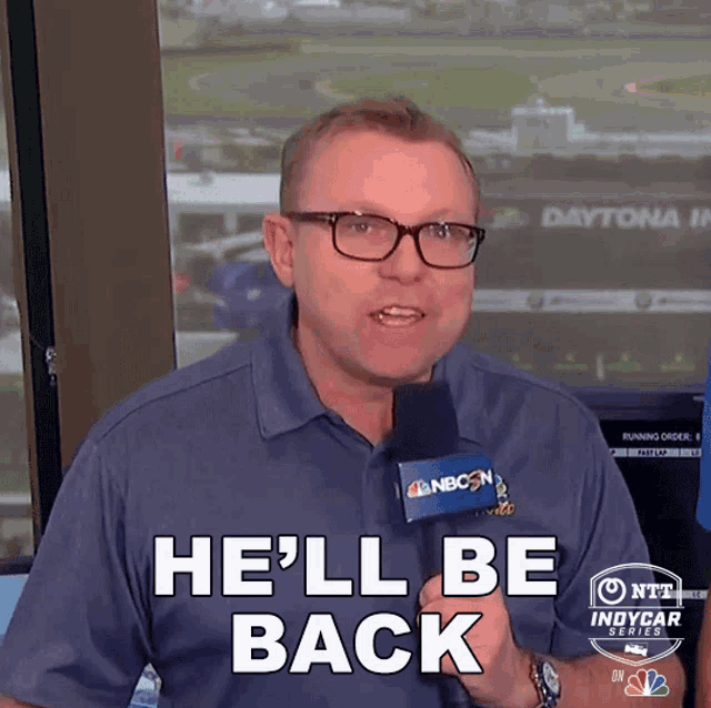 a man holding a microphone that says he 'll be back on it