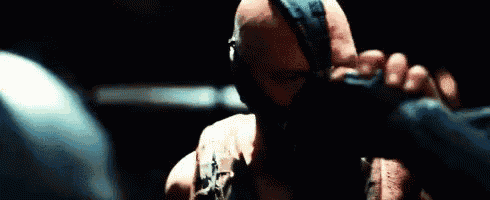 a bald man with a beard is wearing boxing gloves in a boxing ring .